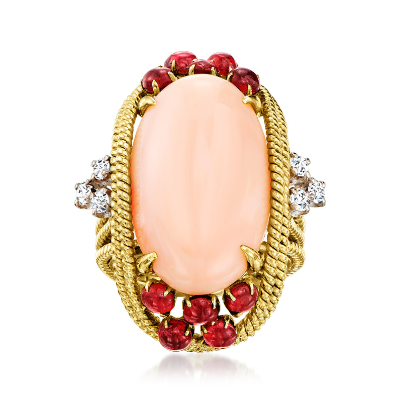 Oval pink coral ring with yellow gold braided halo, red garnets and small diamonds