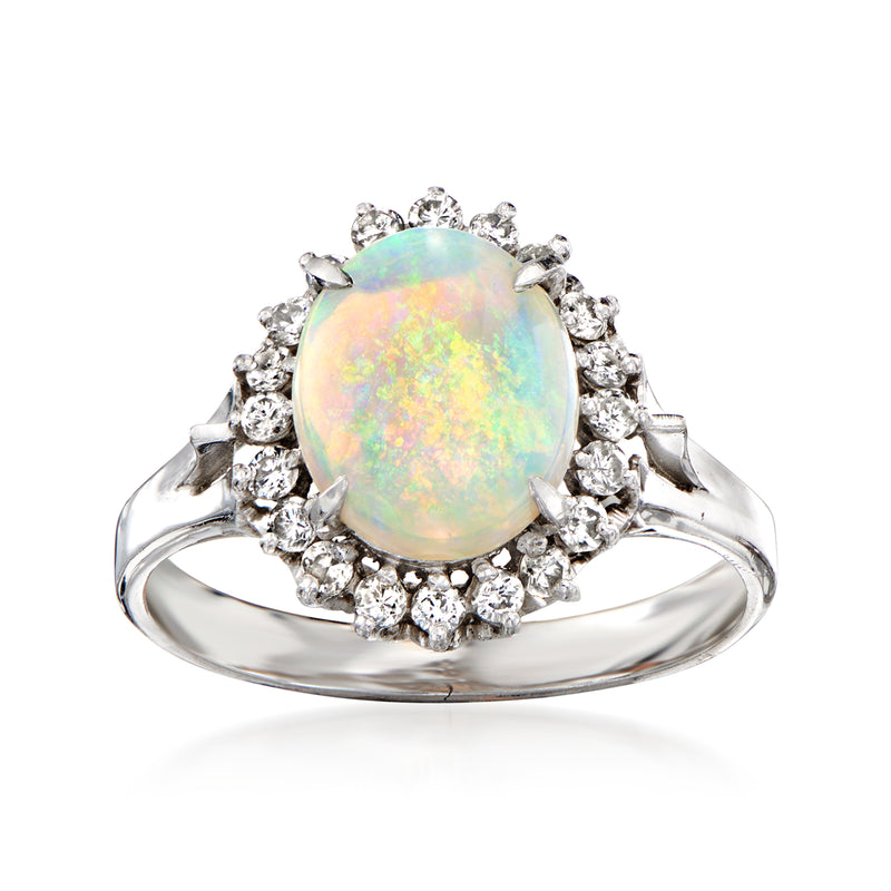 Platinum opal and diamond halo ring with oval opal center and round diamond border