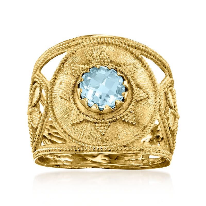 Gold Etruscan-style ring with oval sky-blue gemstone in ornate bezel
