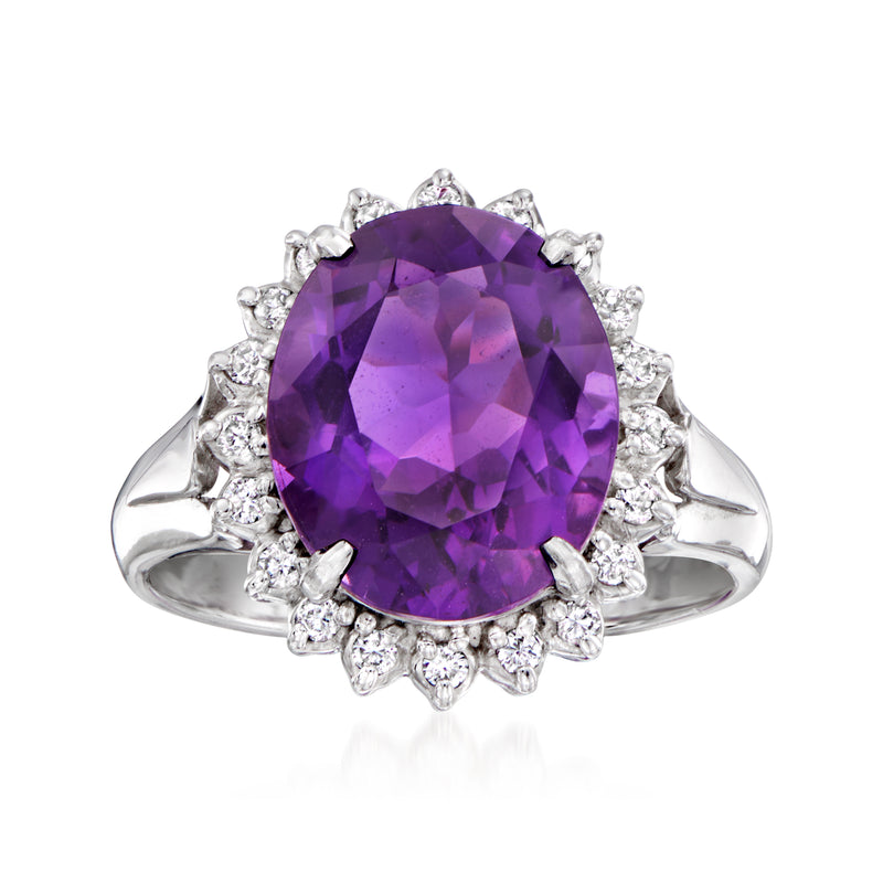 Platinum ring with large oval amethyst center and diamond halo and shoulders