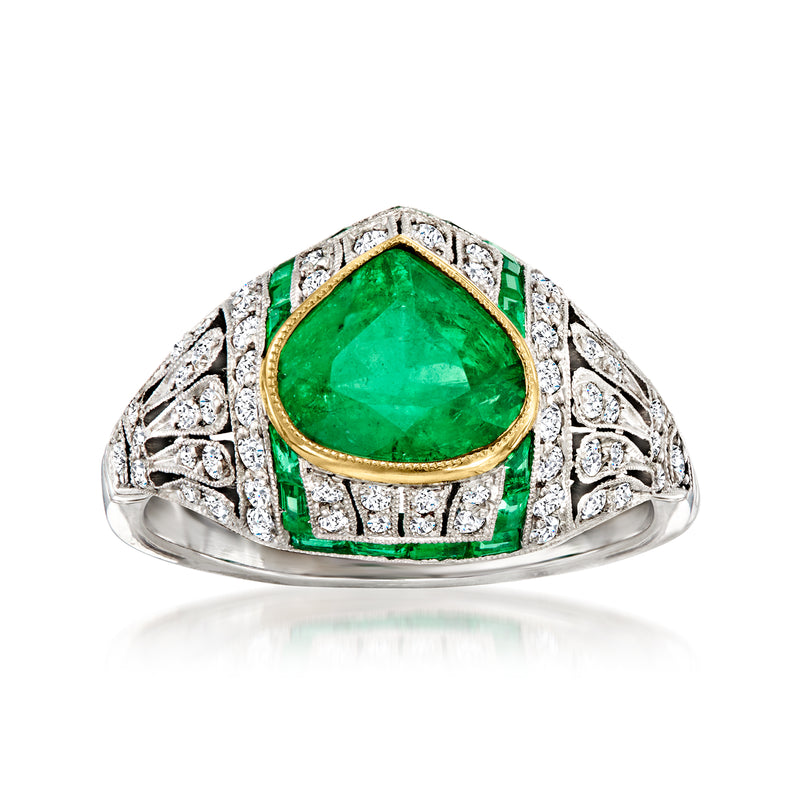 Vintage emerald and diamond ring with green pear-cut center, platinum, yellow-gold bezel