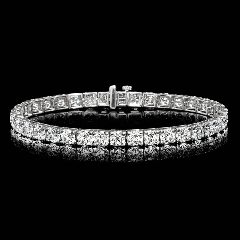 White gold diamond tennis bracelet with round stones and central box clasp