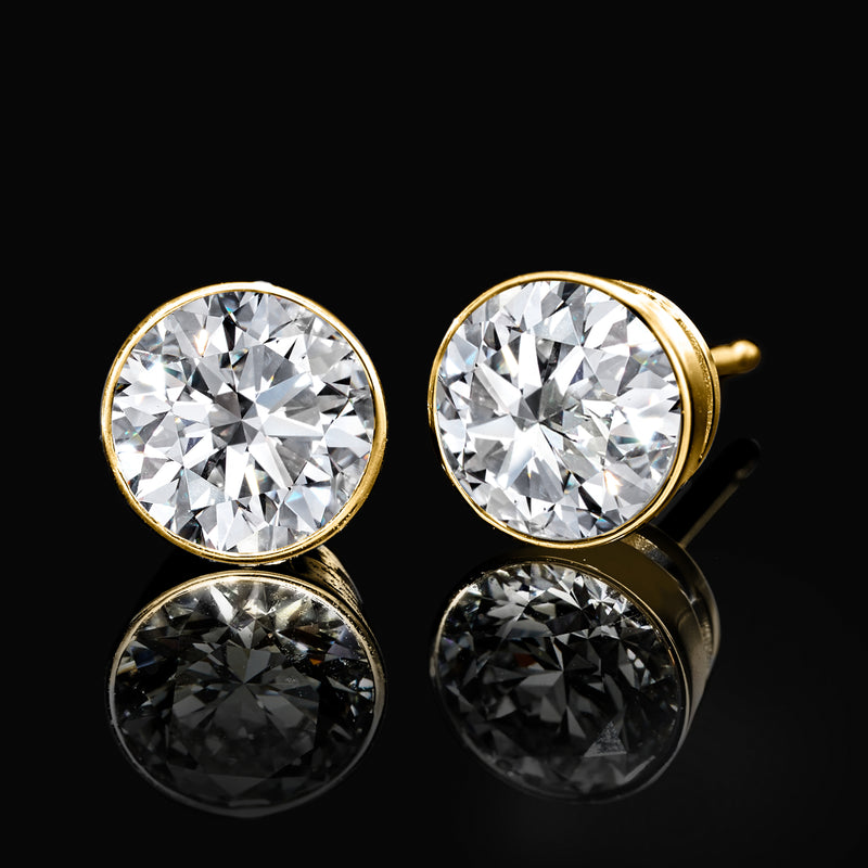 Round diamond stud earrings in 14kt yellow gold bezel setting