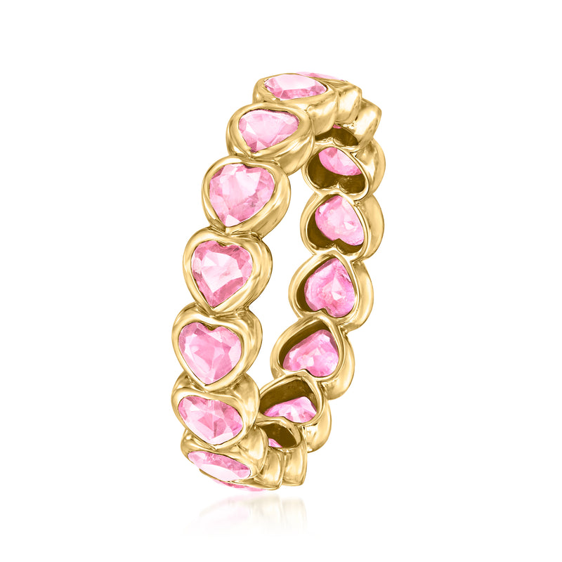 Yellow gold eternity band with rows of pink heart-shaped gemstones, side view