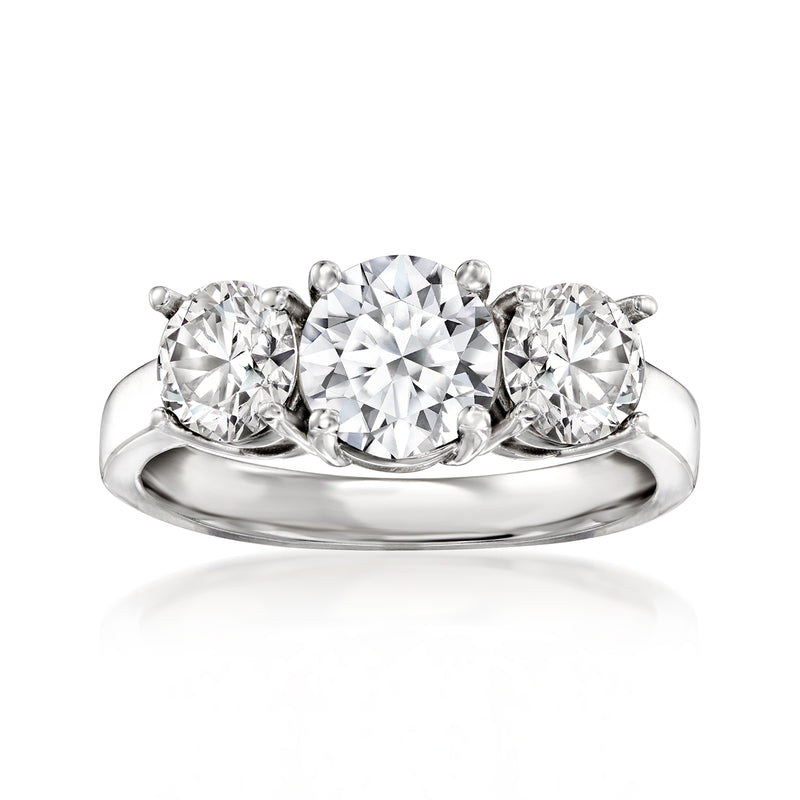 Three-stone diamond ring in 14kt white gold with round center and two side diamonds