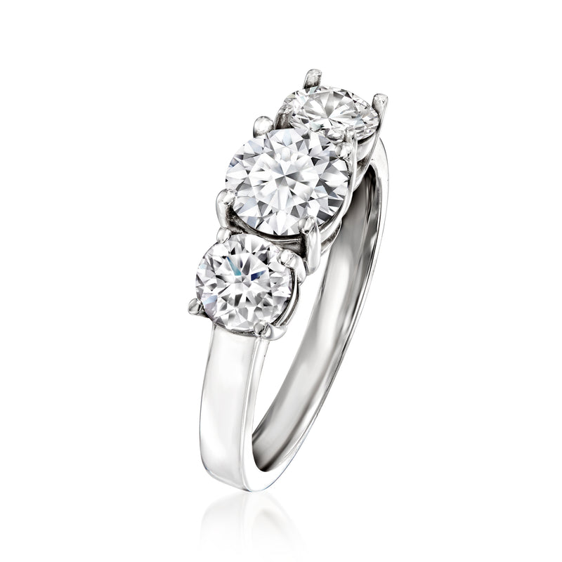 14kt white gold three-stone diamond ring, side view showing three round prong-set stones