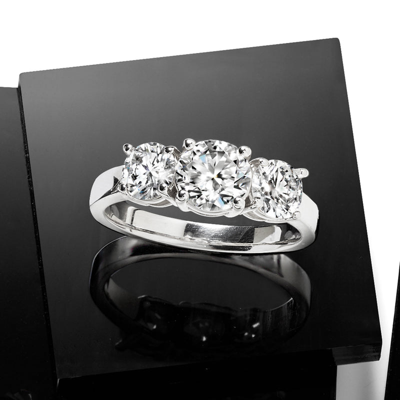 Three-stone diamond ring in 14kt white gold with three round diamonds, polished band