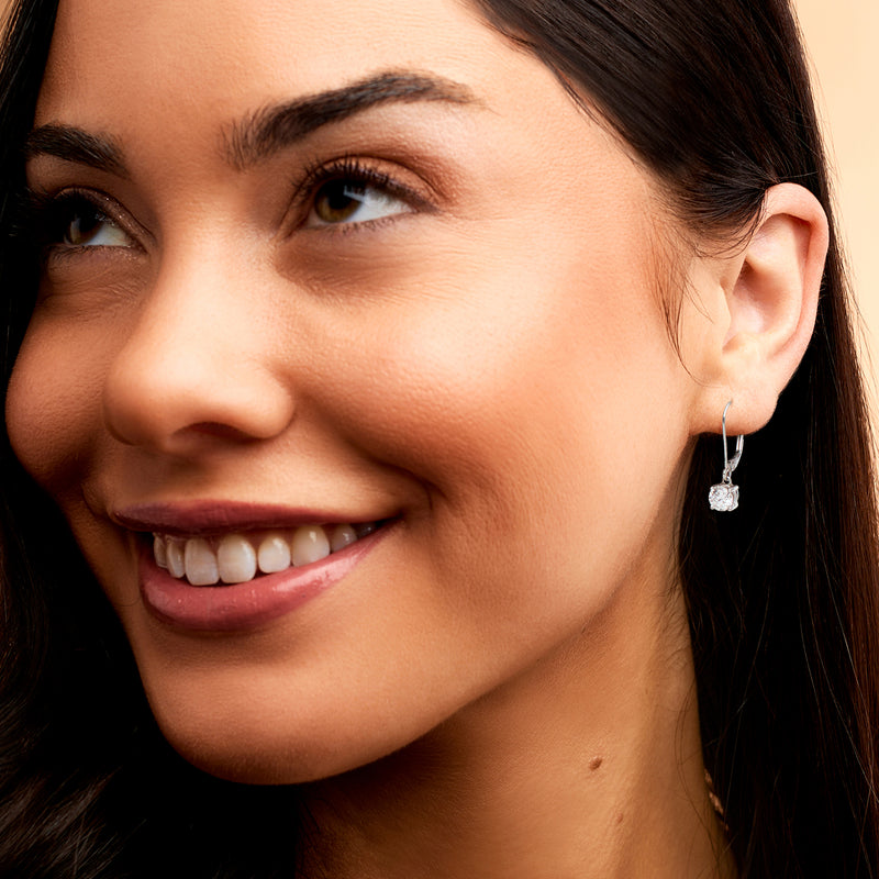 14kt white gold leverback diamond drop earrings on a woman’s ear