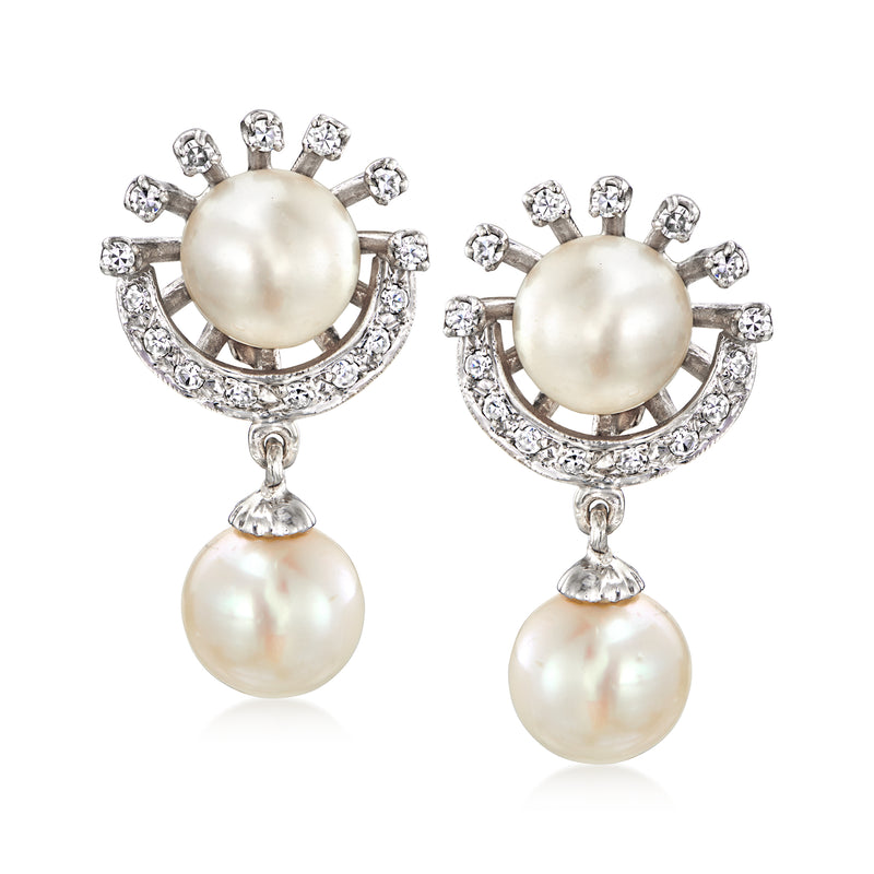 Cultured pearl drop earrings in white gold with diamond-like stone halos and dangling pearls
