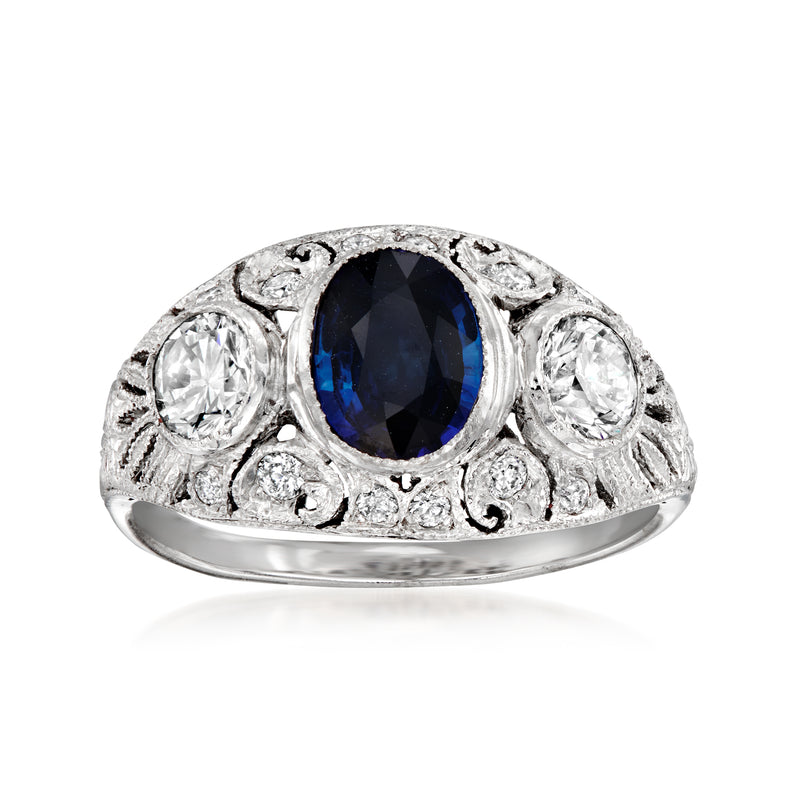 Vintage oval sapphire and diamond halo ring in 18kt white gold, ornate prong setting