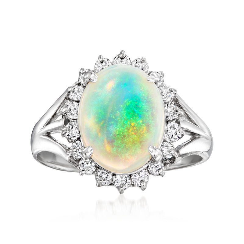 Opal and diamond vintage ring in platinum, oval opal center with halo of round stones