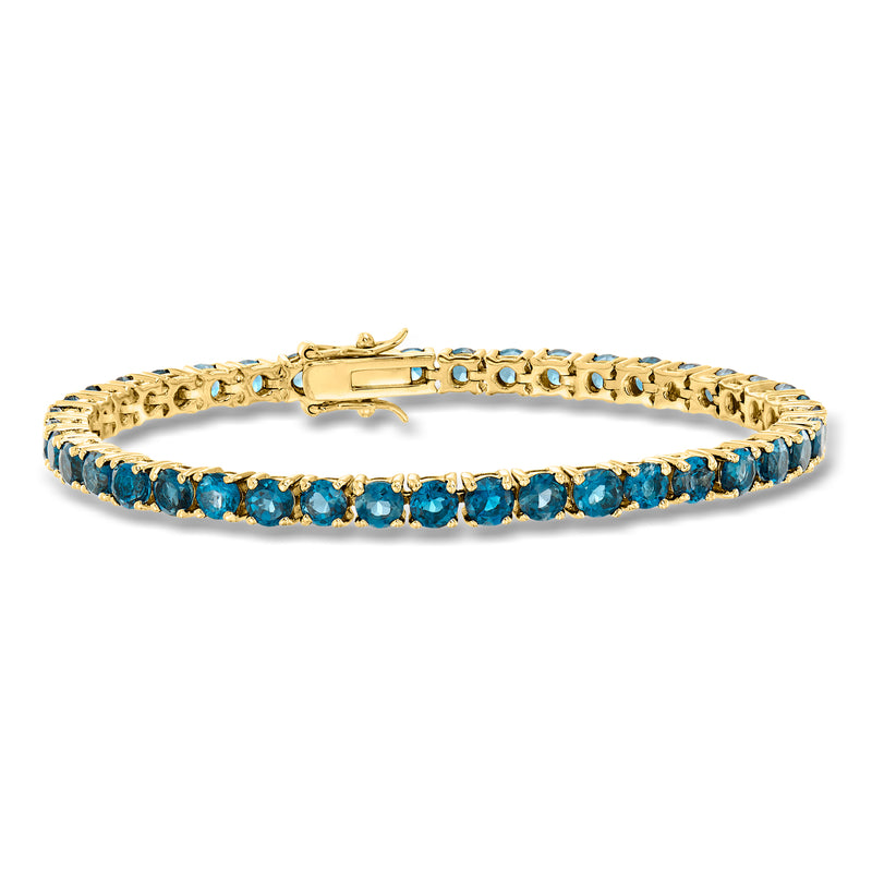 Gold tennis bracelet with blue London topaz stations and linked setting