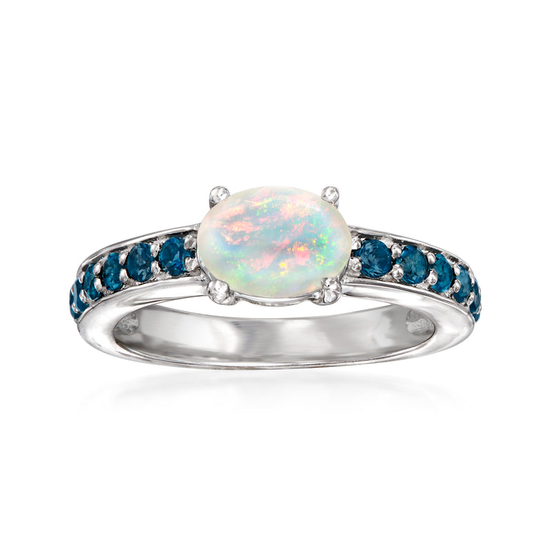 Sterling silver ring with oval Ethiopian opal center and round blue topaz side stones