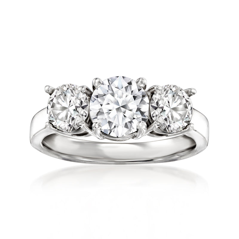 Three-stone diamond ring in 14kt white gold with round center and side stones