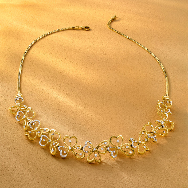 Gold-tone floral diamond necklace flat lay with clover flower links and chain
