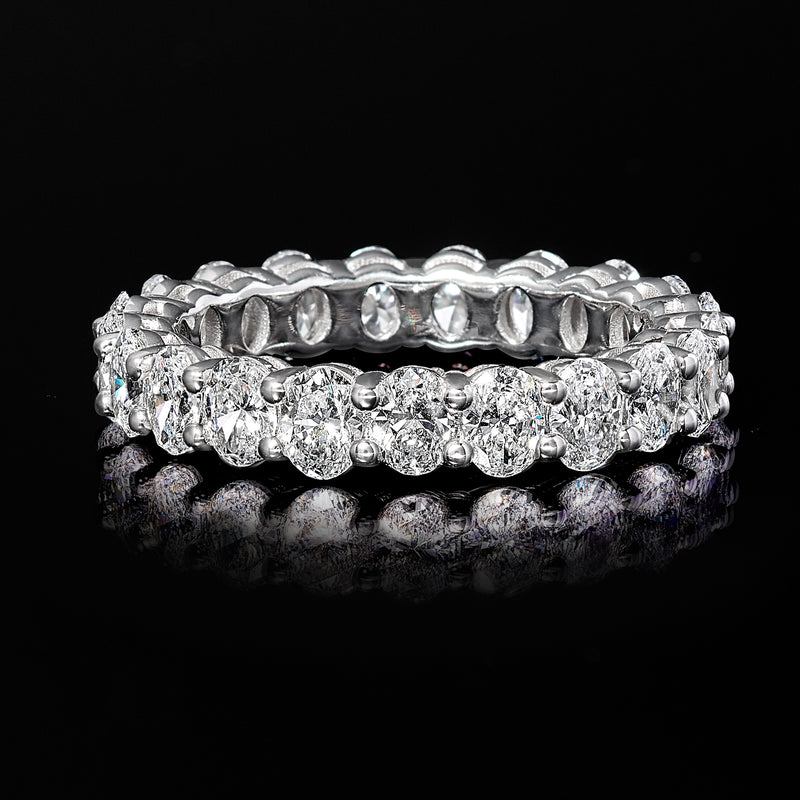 Oval lab-grown diamond eternity band in 14kt white gold with raised bezel details.