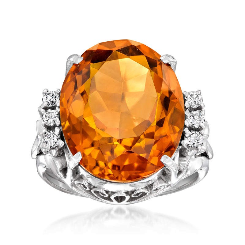 Platinum vintage-style ring with large oval citrine gemstone and diamond cluster shoulders