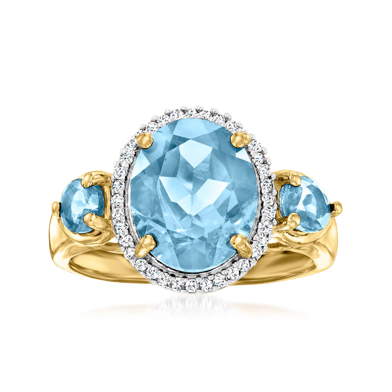 Oval sky-blue topaz halo ring with diamond accents and gold setting
