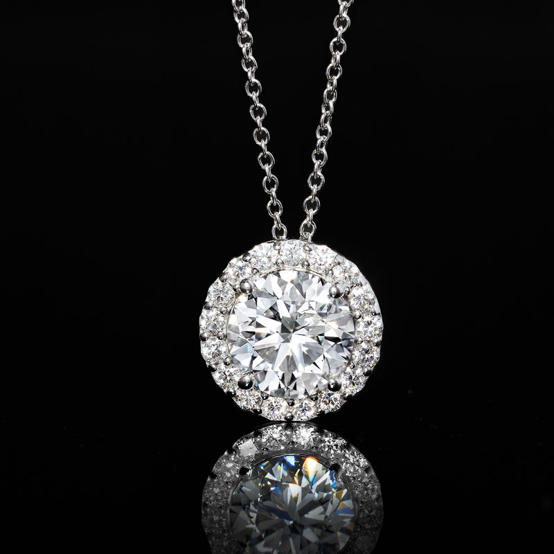 White gold round halo diamond pendant with large center stone, hanging on chain