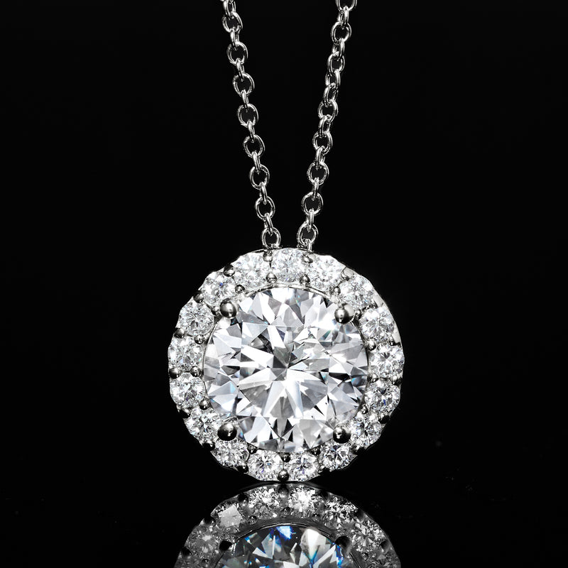 Close-up round diamond halo pendant with prong-set center stone on white gold chain