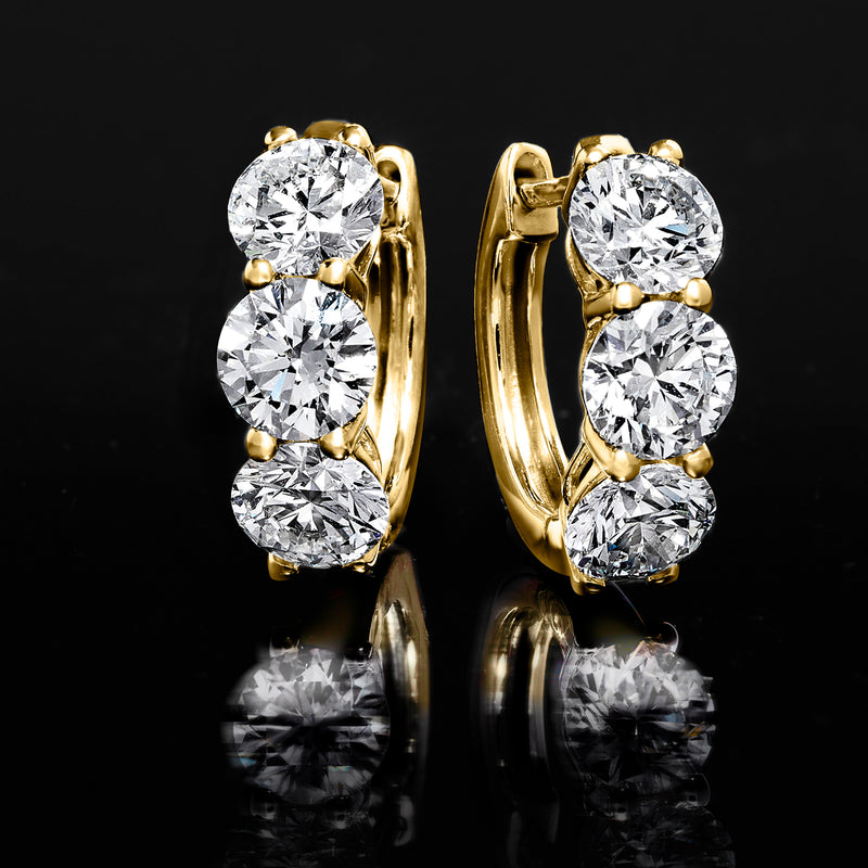 14kt yellow gold huggie hoop earrings with three round diamonds, front close-up