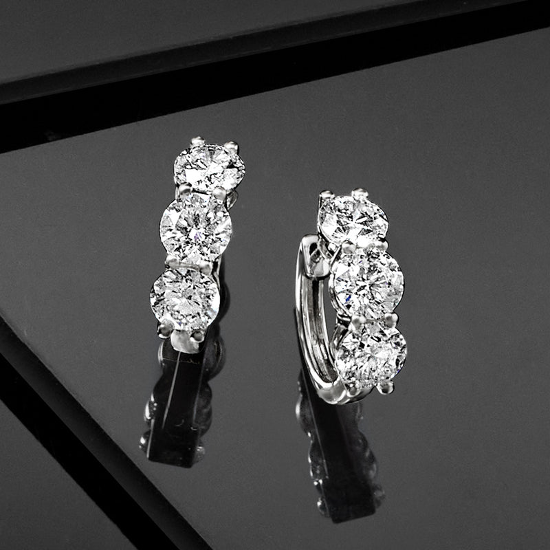 Three-stone huggie hoop earrings in 14kt white gold with round lab-grown diamonds