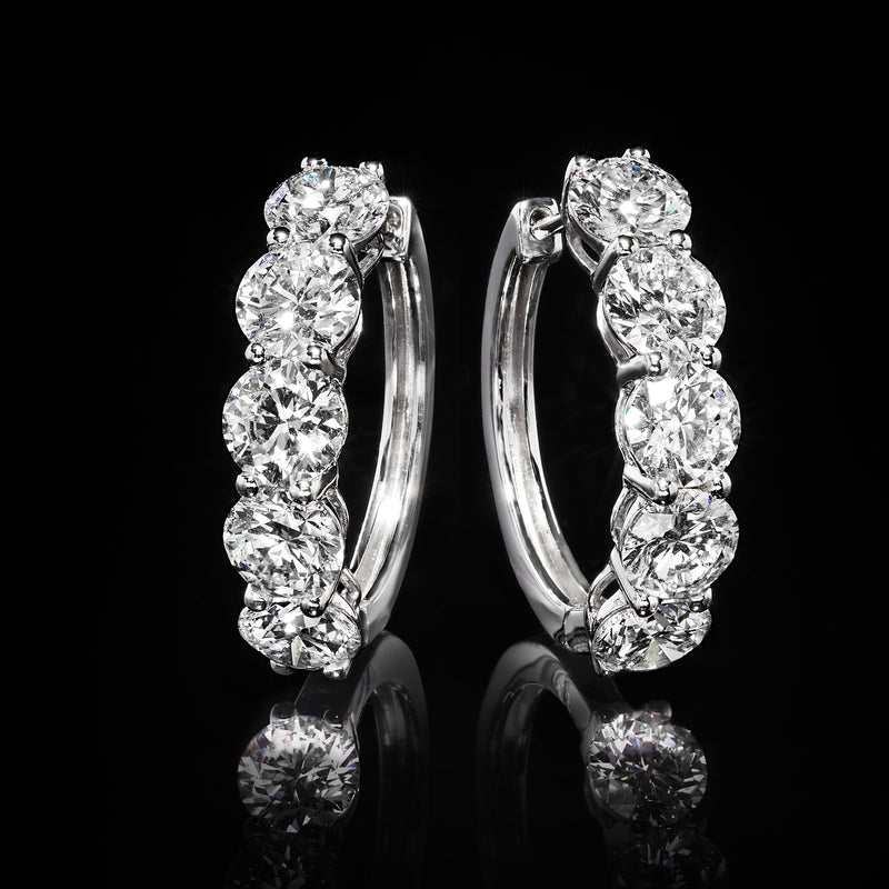 Five-stone diamond hoop earrings, round bezel-set stones on white gold hoops