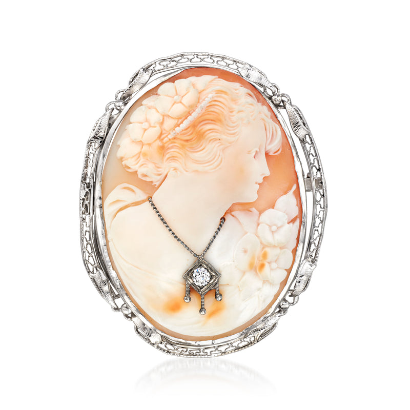Oval shell cameo pin in white gold filigree, with side-profile portrait and diamond accents