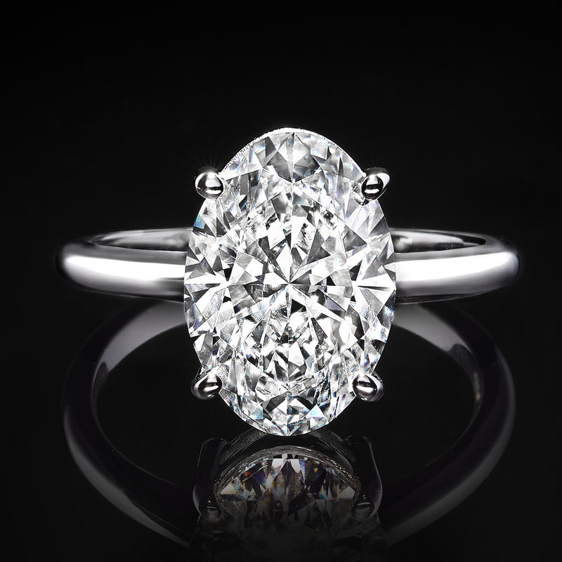 Oval diamond solitaire ring in 14k white gold with four-prong setting and polished band