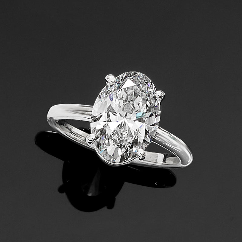 Oval diamond solitaire ring in 14k white gold, side view showing prongs and band profile