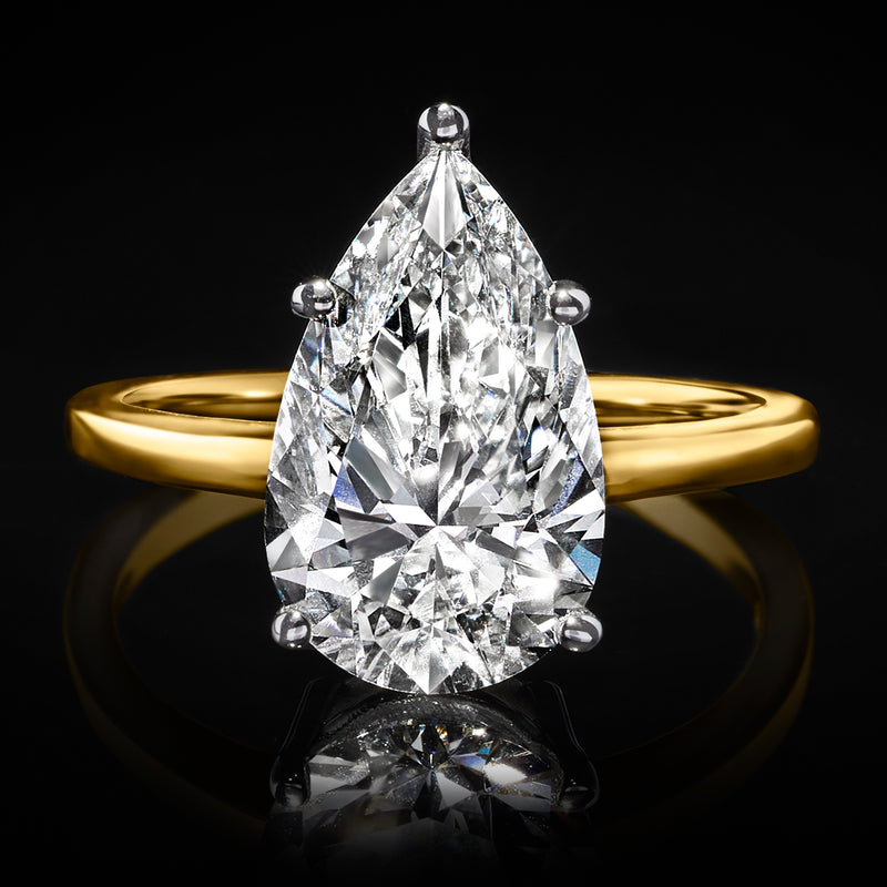 14kt yellow gold solitaire ring featuring a large pear-shaped clear diamond