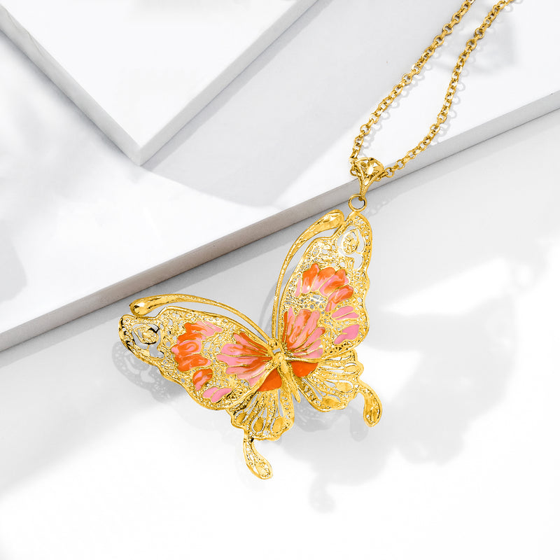 Enamel butterfly pendant on gold chain with pink, orange, and gold tones