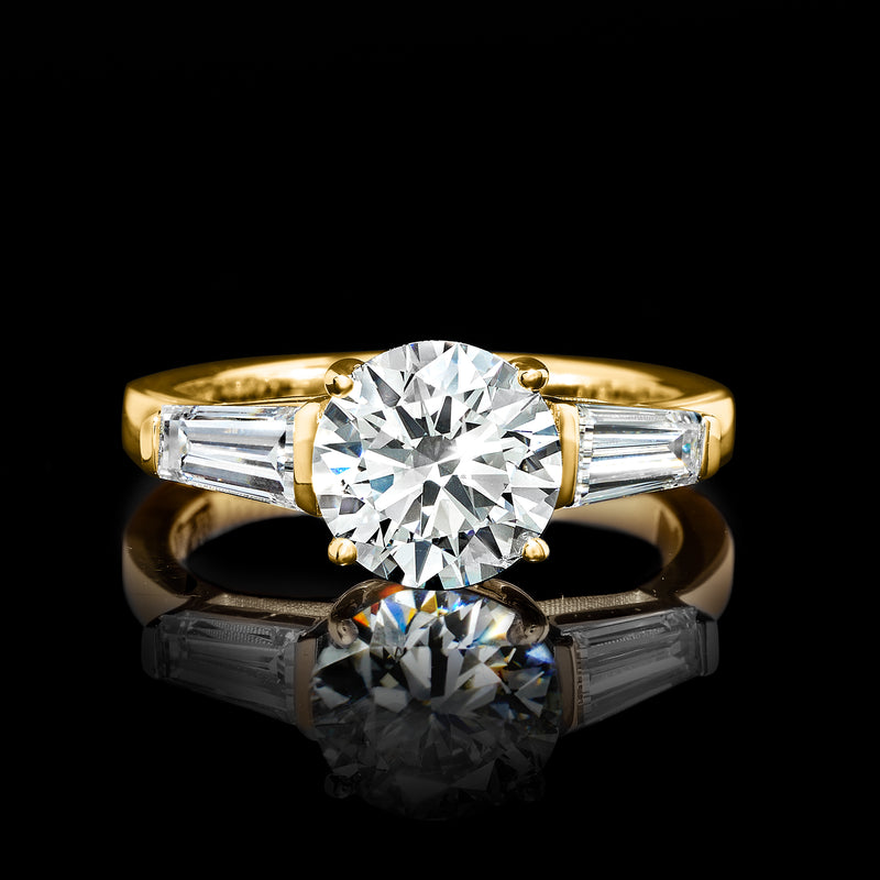 14kt yellow gold diamond ring with round center stone and baguette side stones