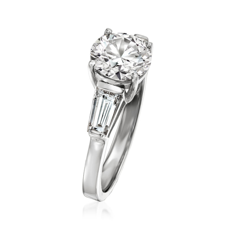 14kt white gold three-stone diamond ring with round center and baguette side stones, side view