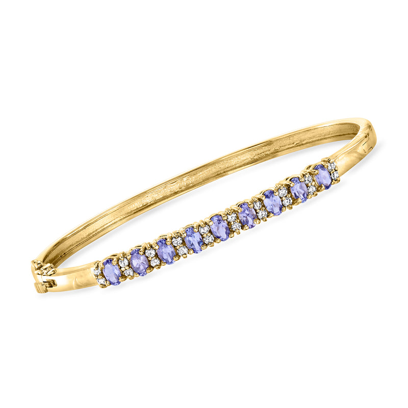 Yellow gold bangle bracelet with row of blue-violet gemstones and diamond accents