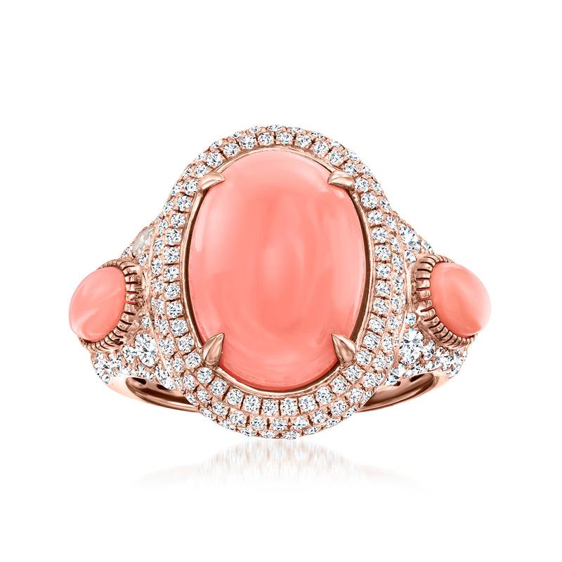 18kt rose gold diamond halo ring with oval coral center and two coral side stones