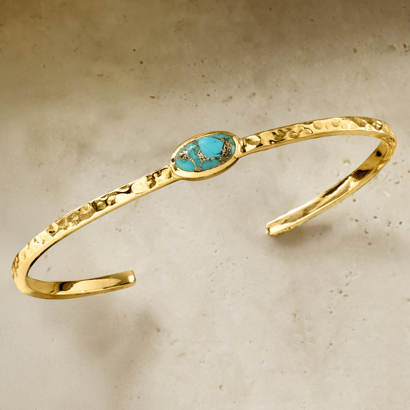 Hammered gold-tone cuff bracelet with turquoise oval center stone