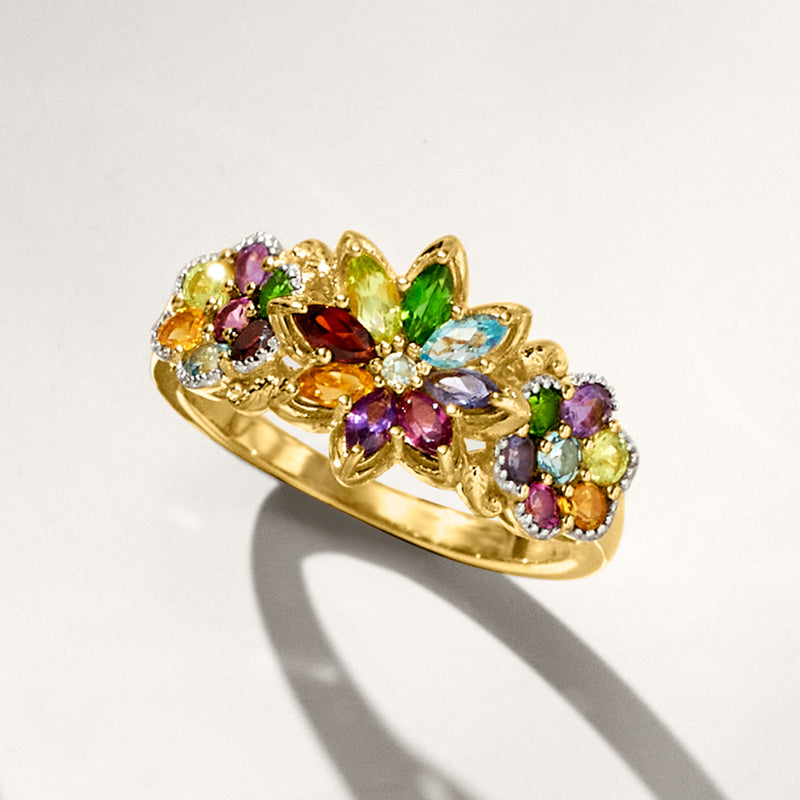 Gold floral ring featuring prong-set gemstones in purple, green, blue, and orange
