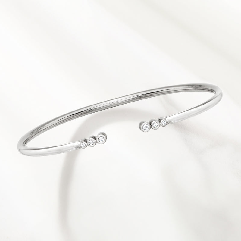 Sterling silver cuff bracelet with open-space design and bezel-set round diamond clusters