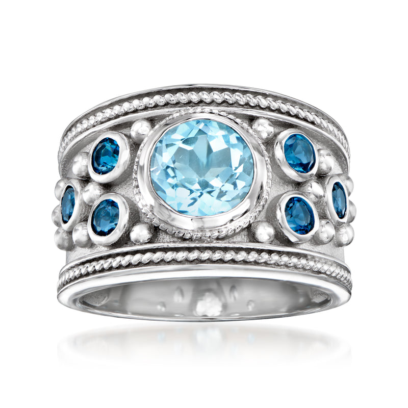 Sterling silver ring with oval sky blue topaz center and blue gemstone side accents