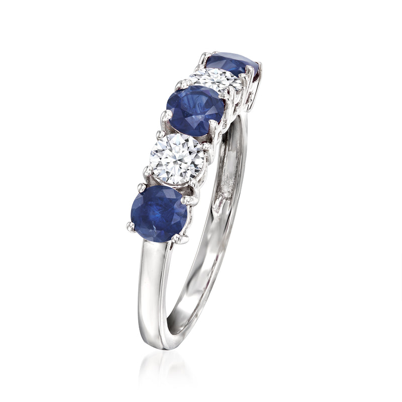 White gold ring with three round sapphires and small clear diamonds in pronged settings