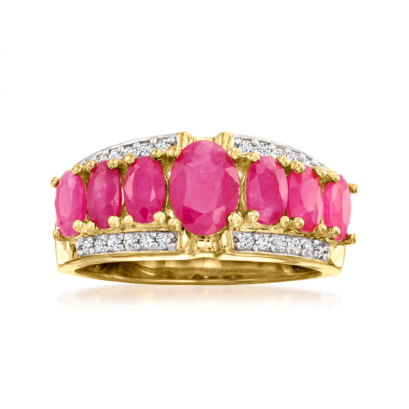 Gold ring with oval pink ruby center, pink side rubies, and diamond accents