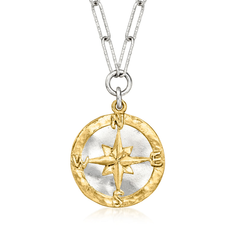 Two-tone compass pendant necklace with circular gold-tone medallion, star detail, and silver chain