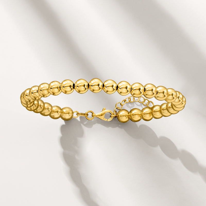 Yellow gold beaded bracelet with round beads and clasp, side view