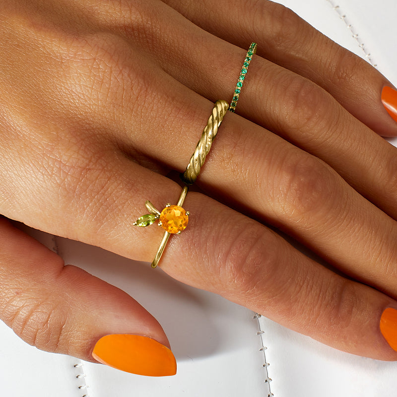 14kt yellow gold ring with green peridot accents and orange citrine round centerpiece on hand