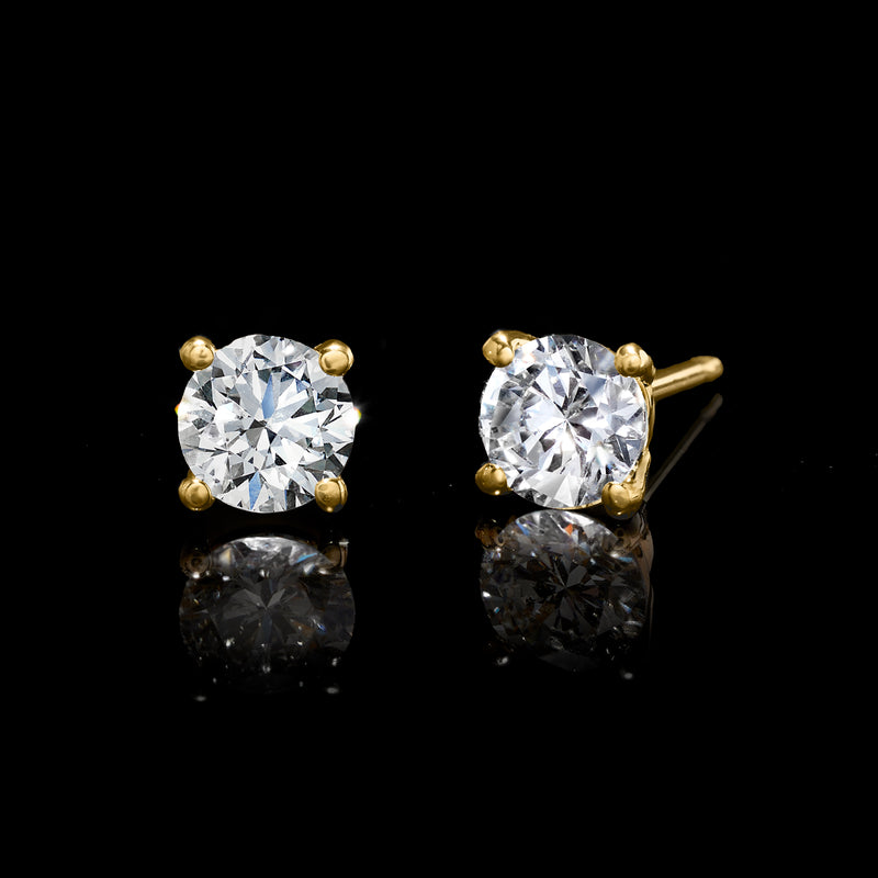 Round lab-grown diamond stud earrings with 14kt yellow gold four-prong setting.