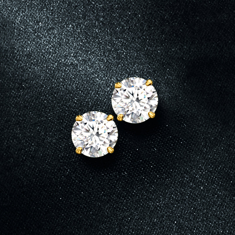 14kt yellow gold moissanite stud earrings with two round stones, close-up on fabric