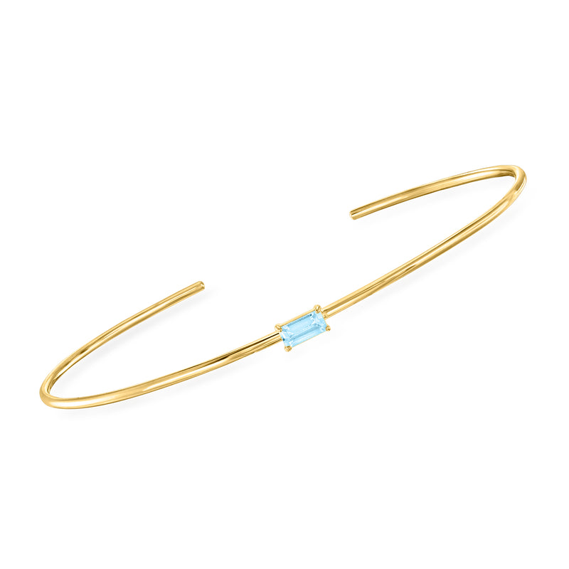 14kt yellow gold cuff bracelet with baguette sky blue topaz centerpiece