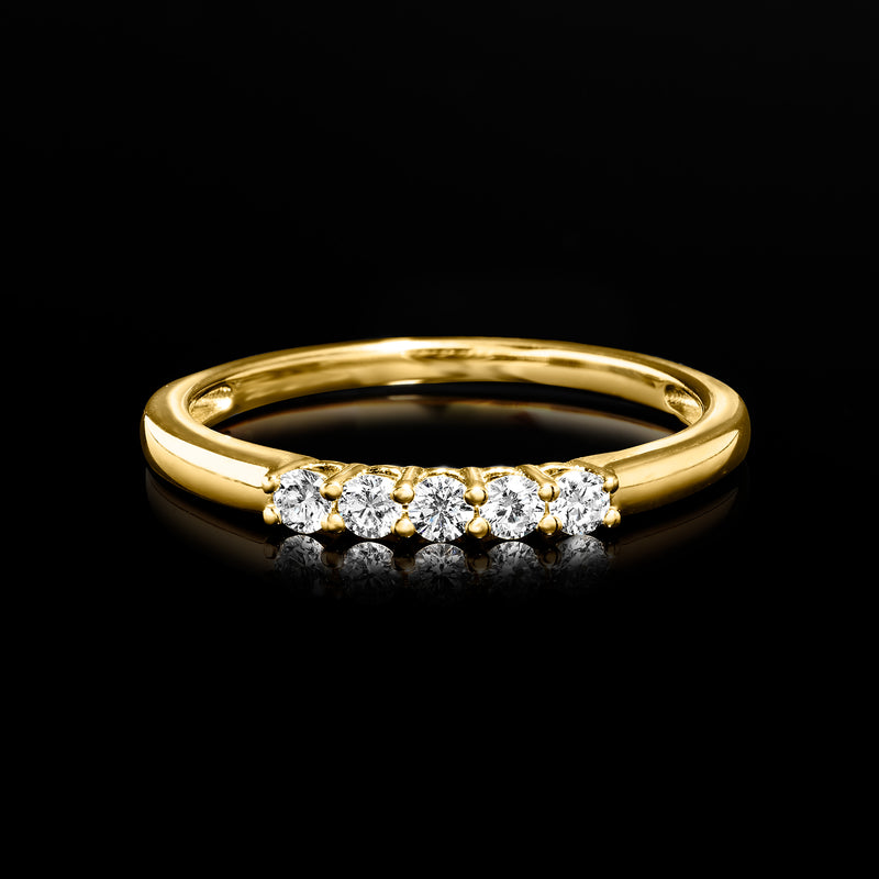 Slim yellow gold band with five round diamonds across the center