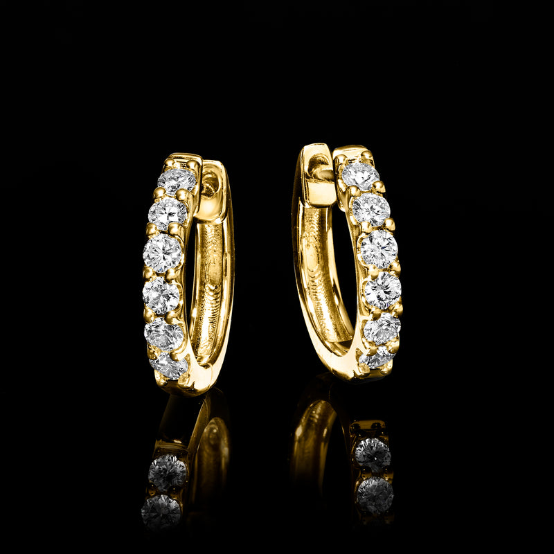Gold hoop earrings with a vertical row of round diamond stones in bezel settings